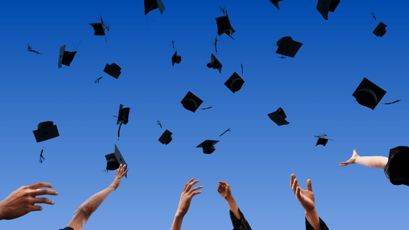 Graduation caps in the air